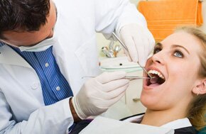 A lady being examined by a dentist
